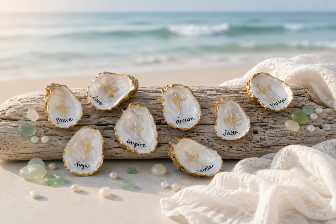 Gilded oyster shell pieces with gold paint edges arranged on driftwood at the beach