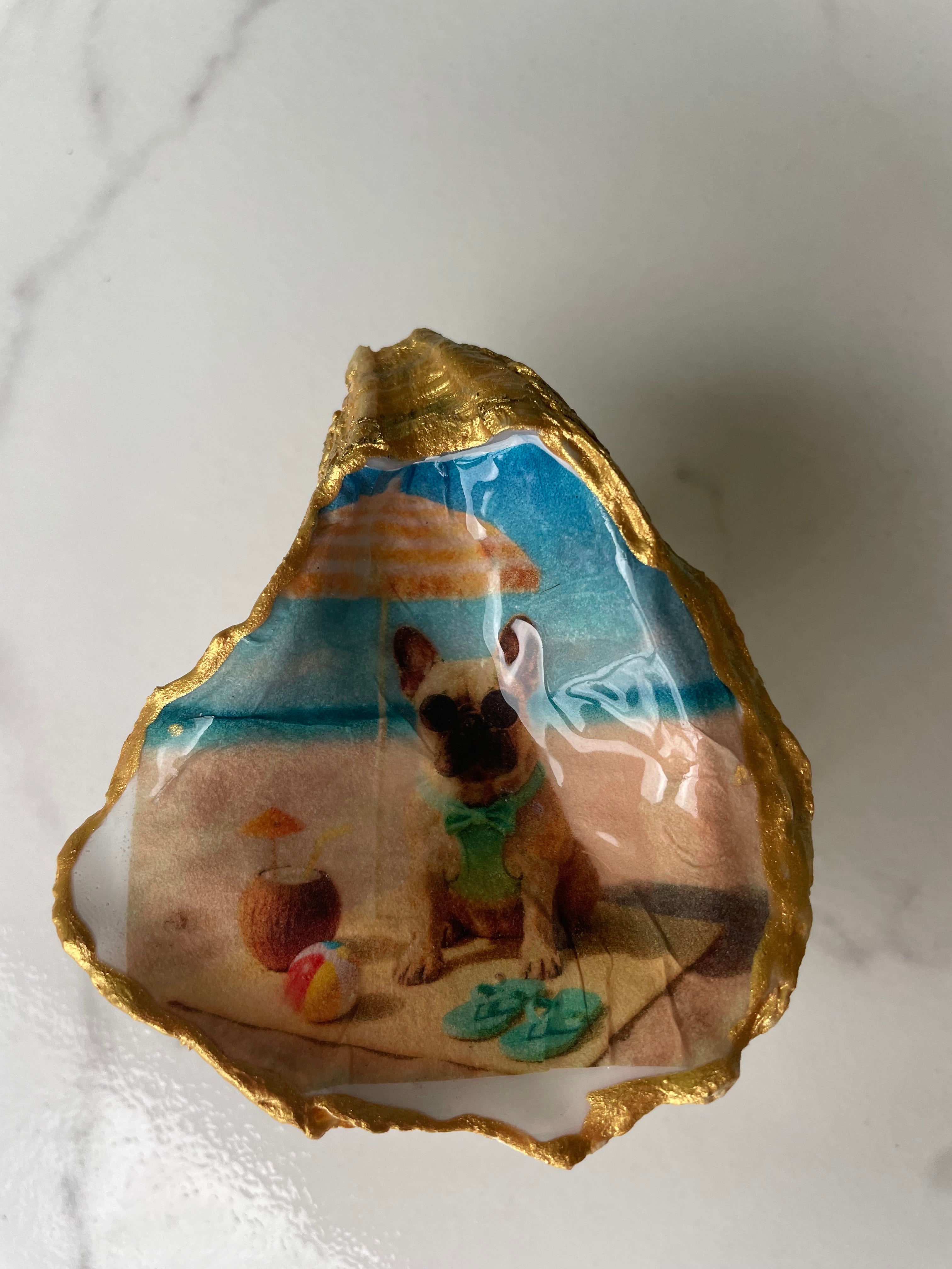 Frenchie Paradise oyster shell trinket dish displayed on its ornate gold stand — handcrafted coastal jewelry dish by The Golden Shoreline