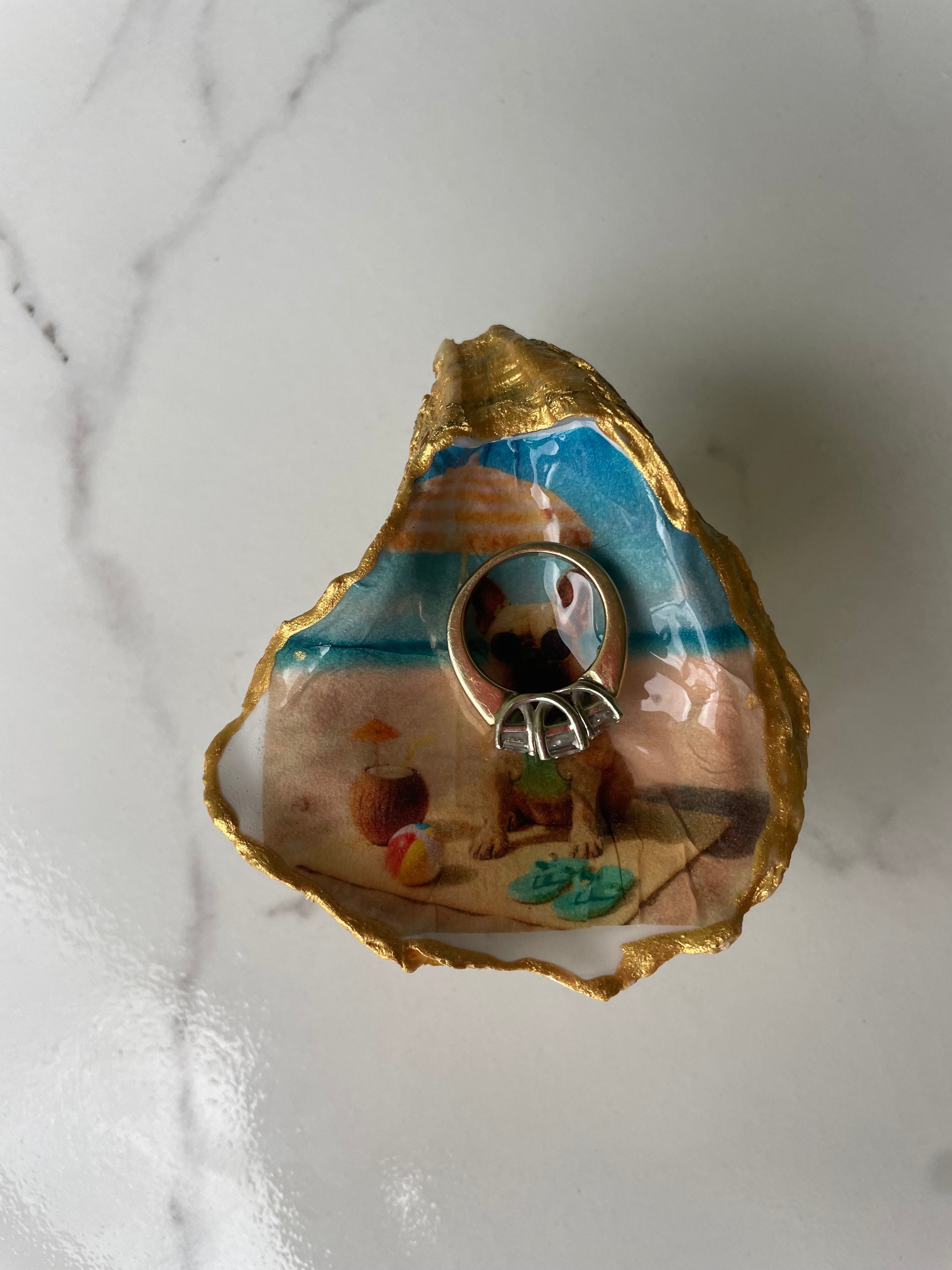 Frenchie Paradise gilded oyster shell trinket dish shown with a ring inside to show size — one-of-a-kind coastal gift for dog lovers