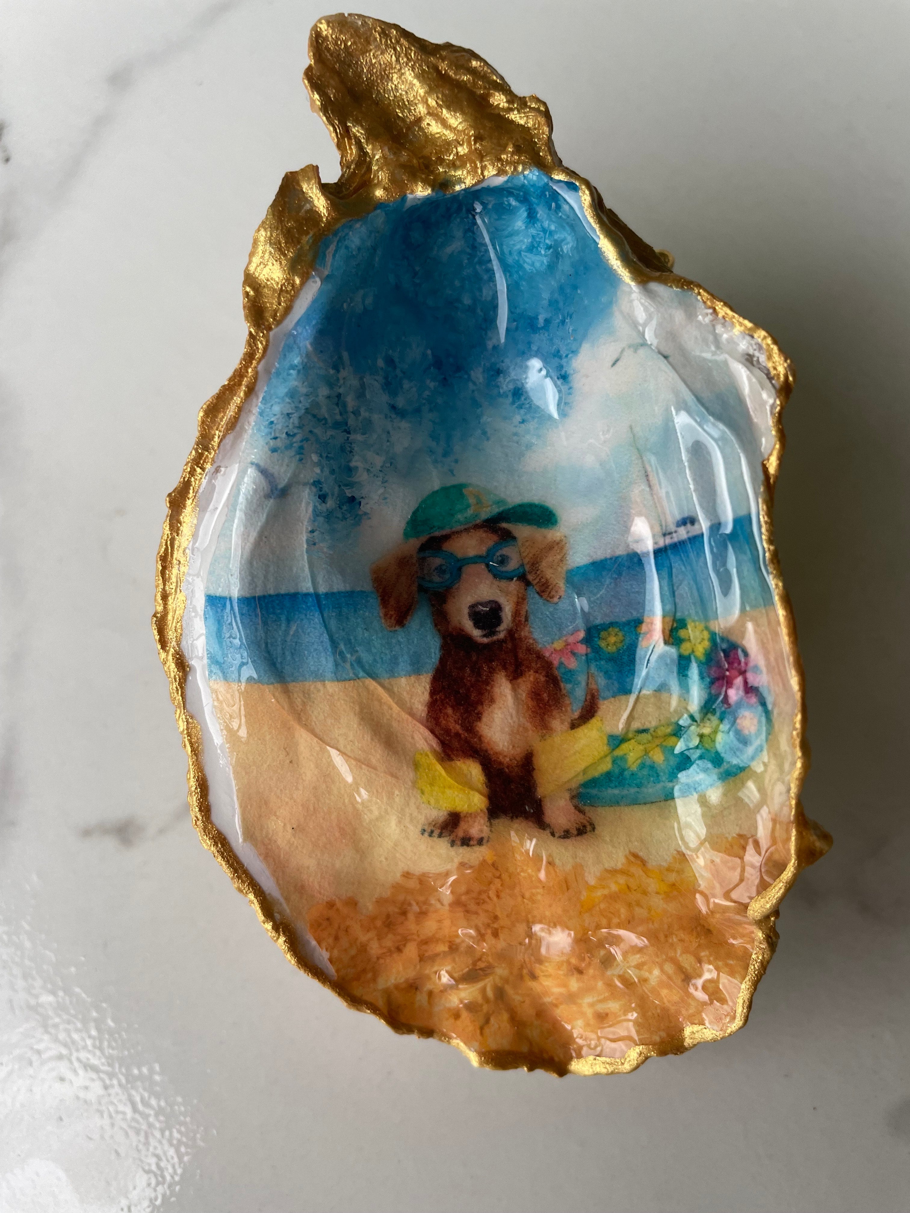 Dachshund Paradise oyster shell trinket dish displayed on its ornate gold stand — handcrafted coastal jewelry dish by The Golden Shoreline