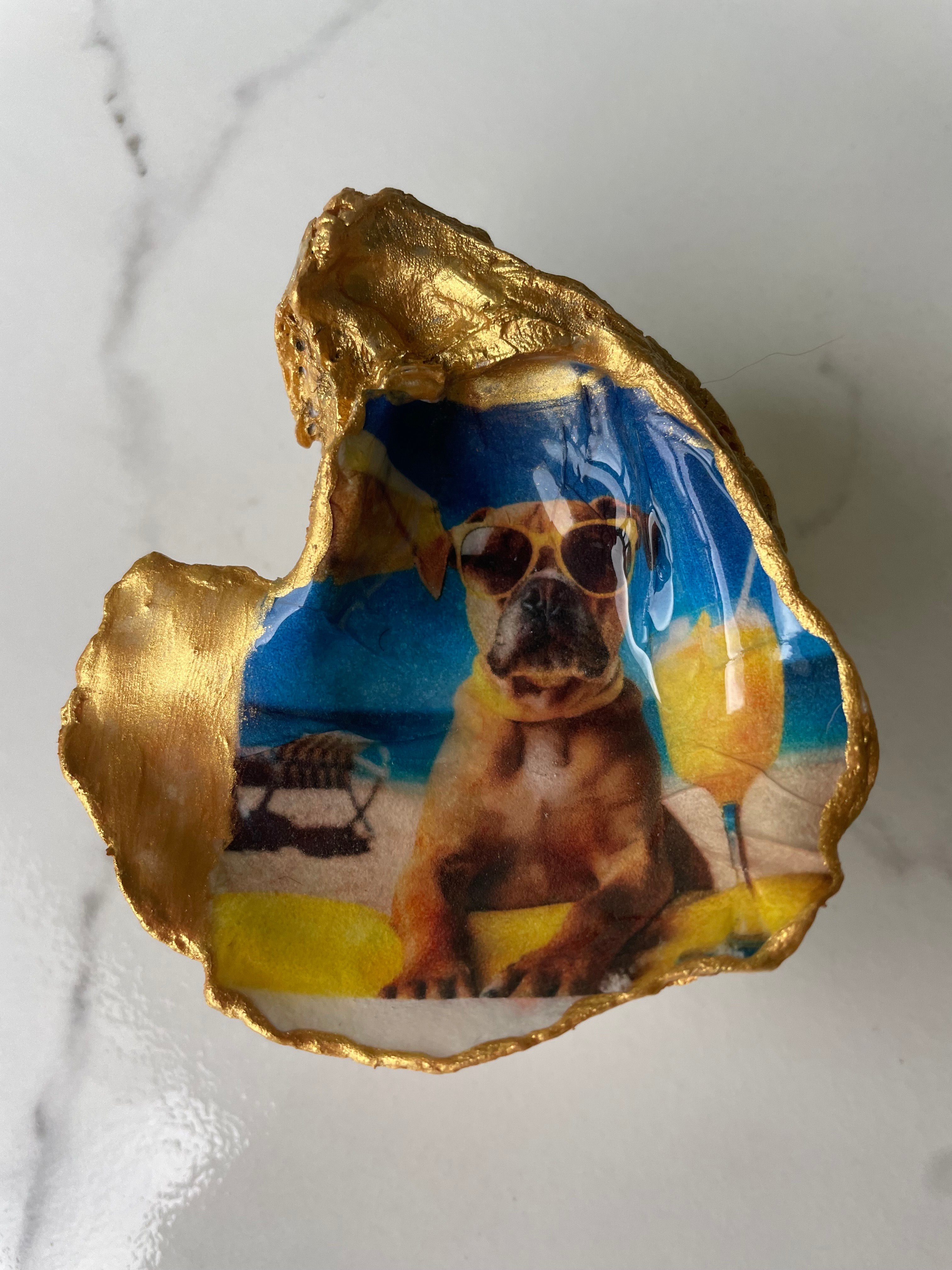 Boxer Paradise oyster shell trinket dish displayed on its ornate gold stand — handcrafted coastal jewelry dish by The Golden Shoreline