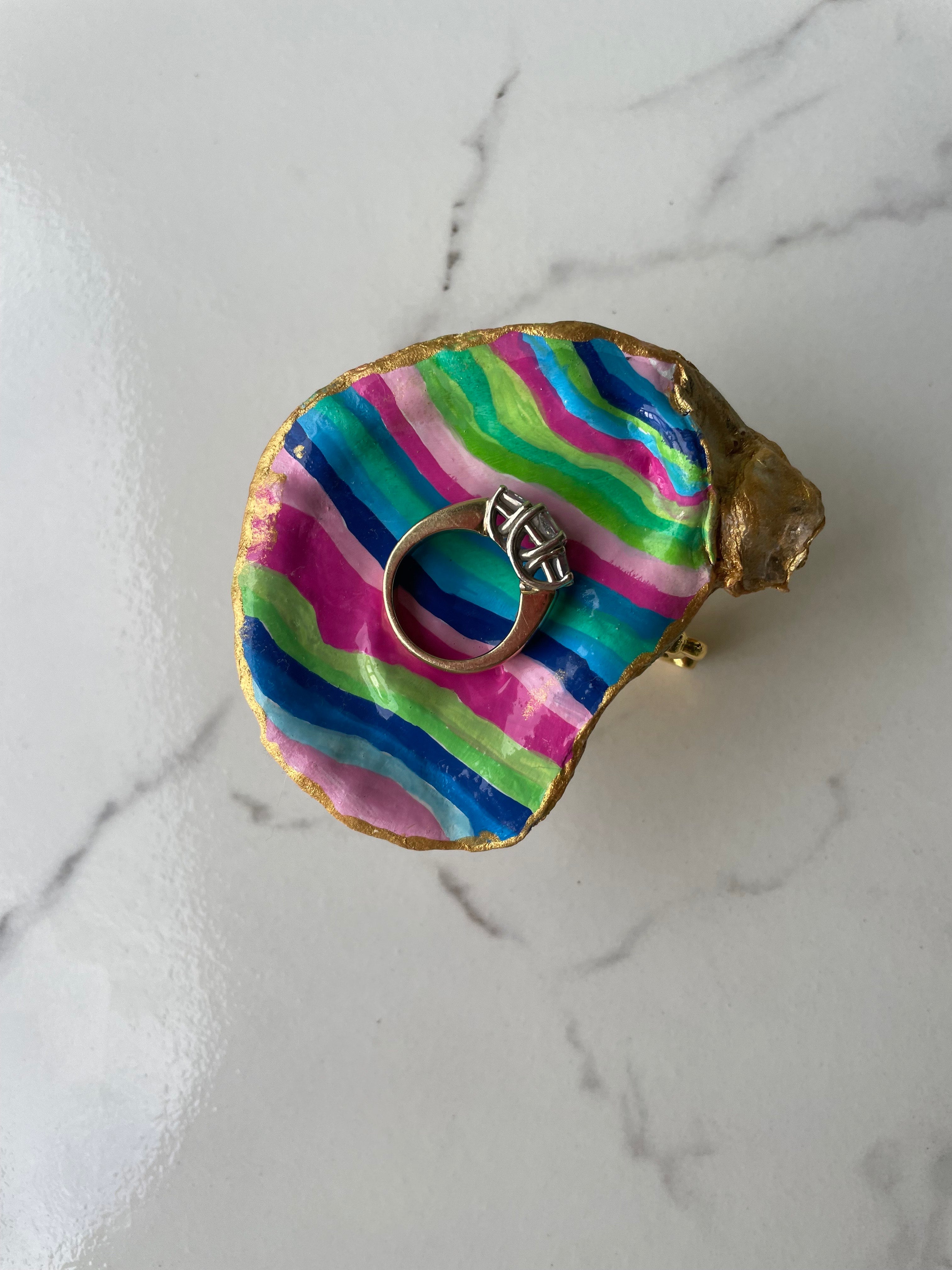Tropical Stripe gilded oyster shell trinket dish shown with ring to display size