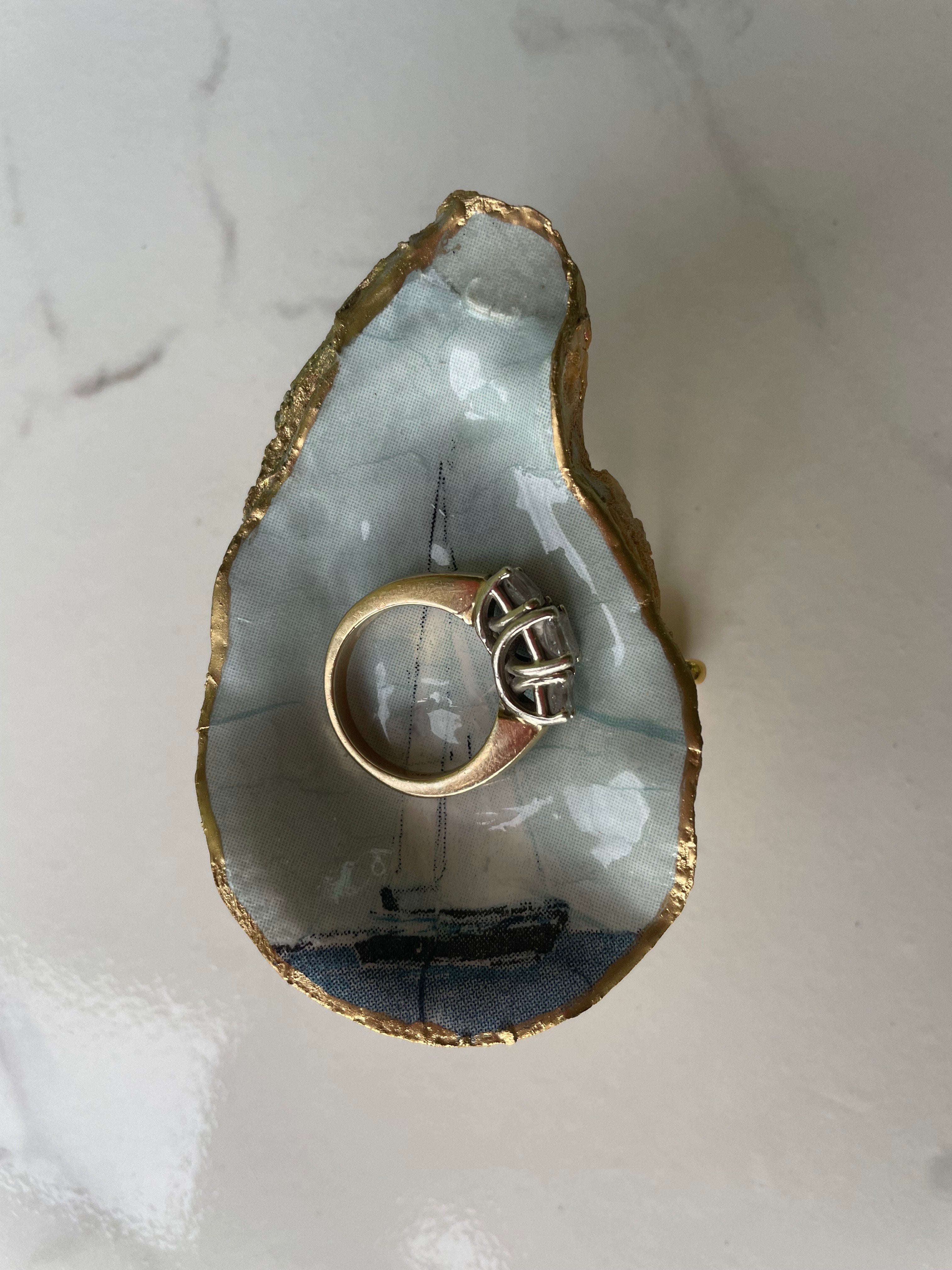 Sailboat gilded oyster shell trinket dish shown with ring to display size
