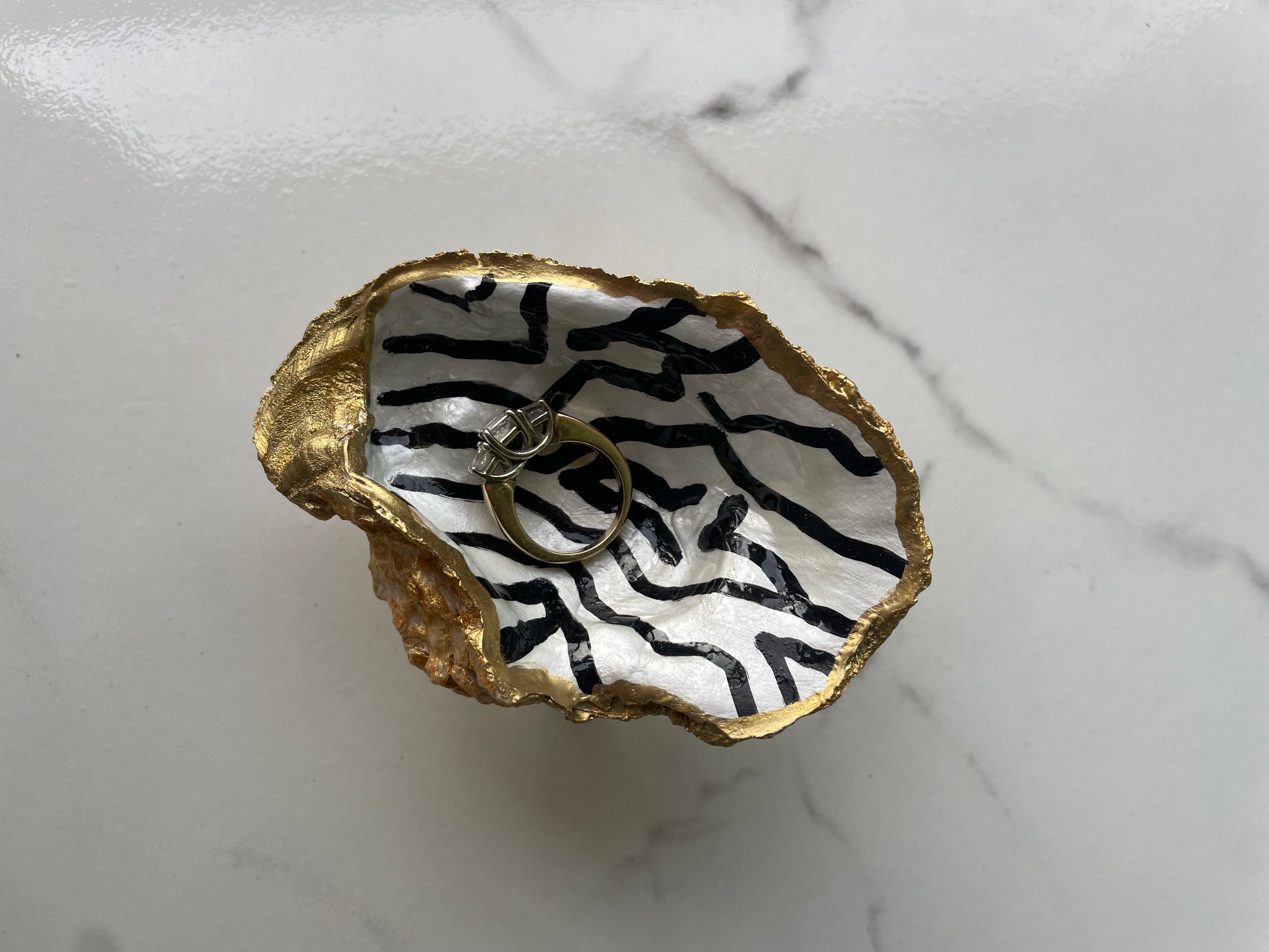 Midnight Stripe gilded oyster shell trinket dish shown with ring to display size
