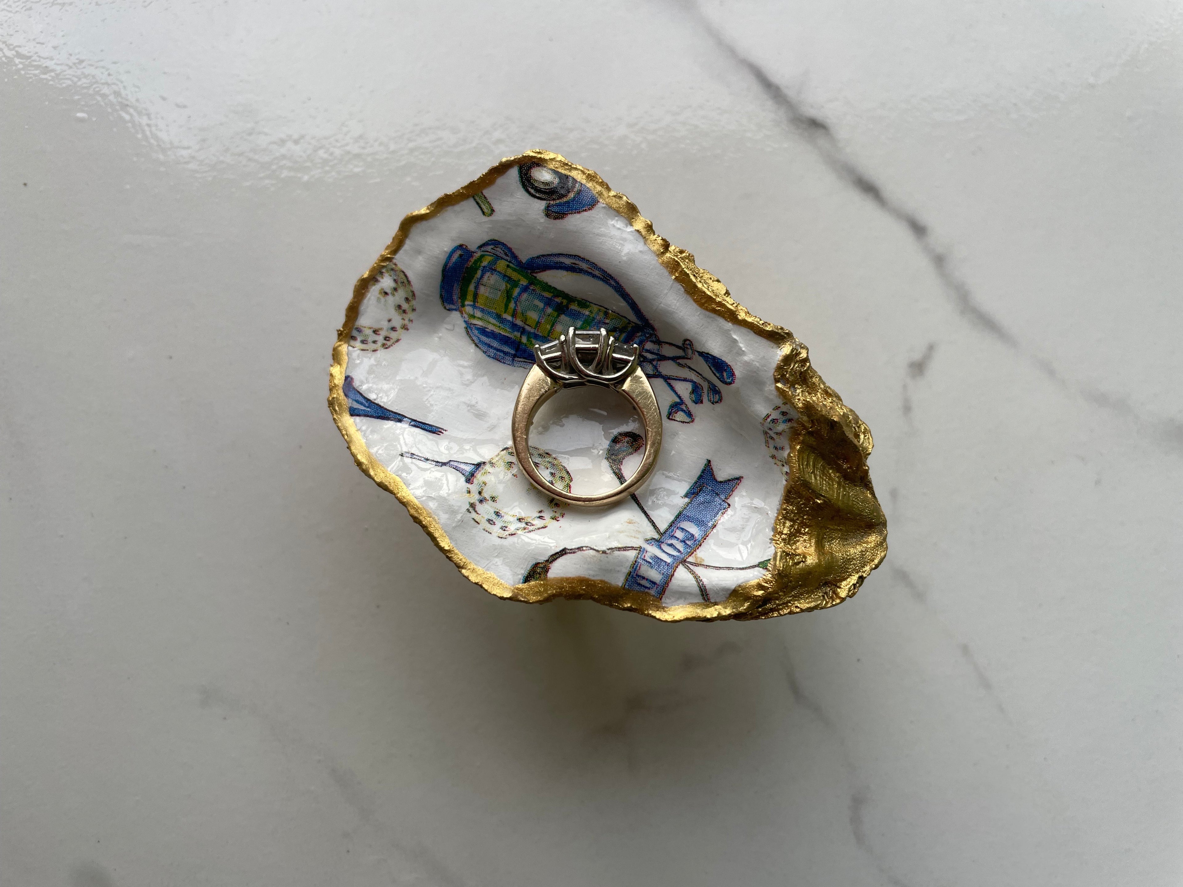 The 19th Hole Keepsake gilded oyster shell trinket dish shown with ring to display size