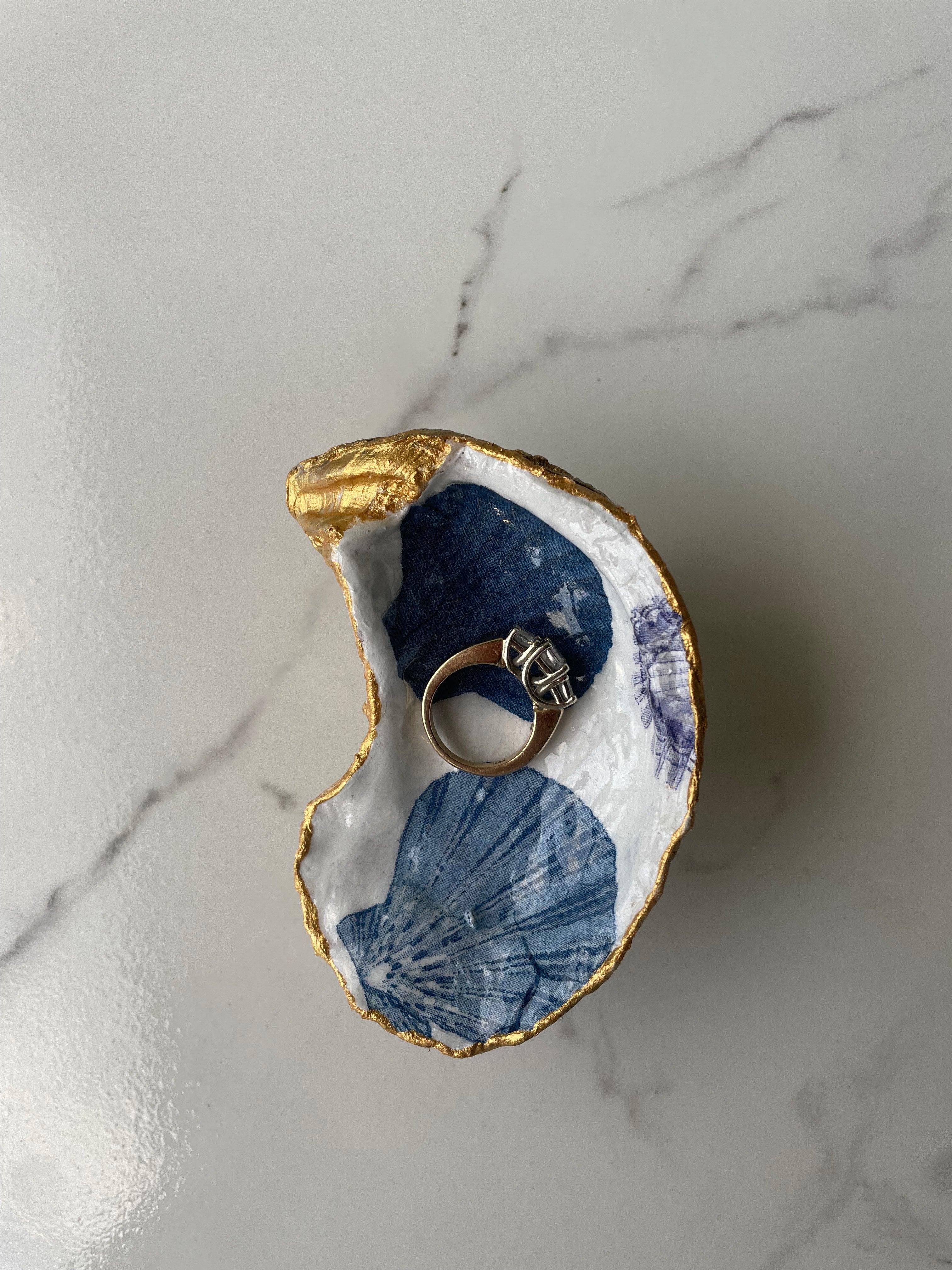 Cobalt gilded oyster shell trinket dish shown with ring to display size