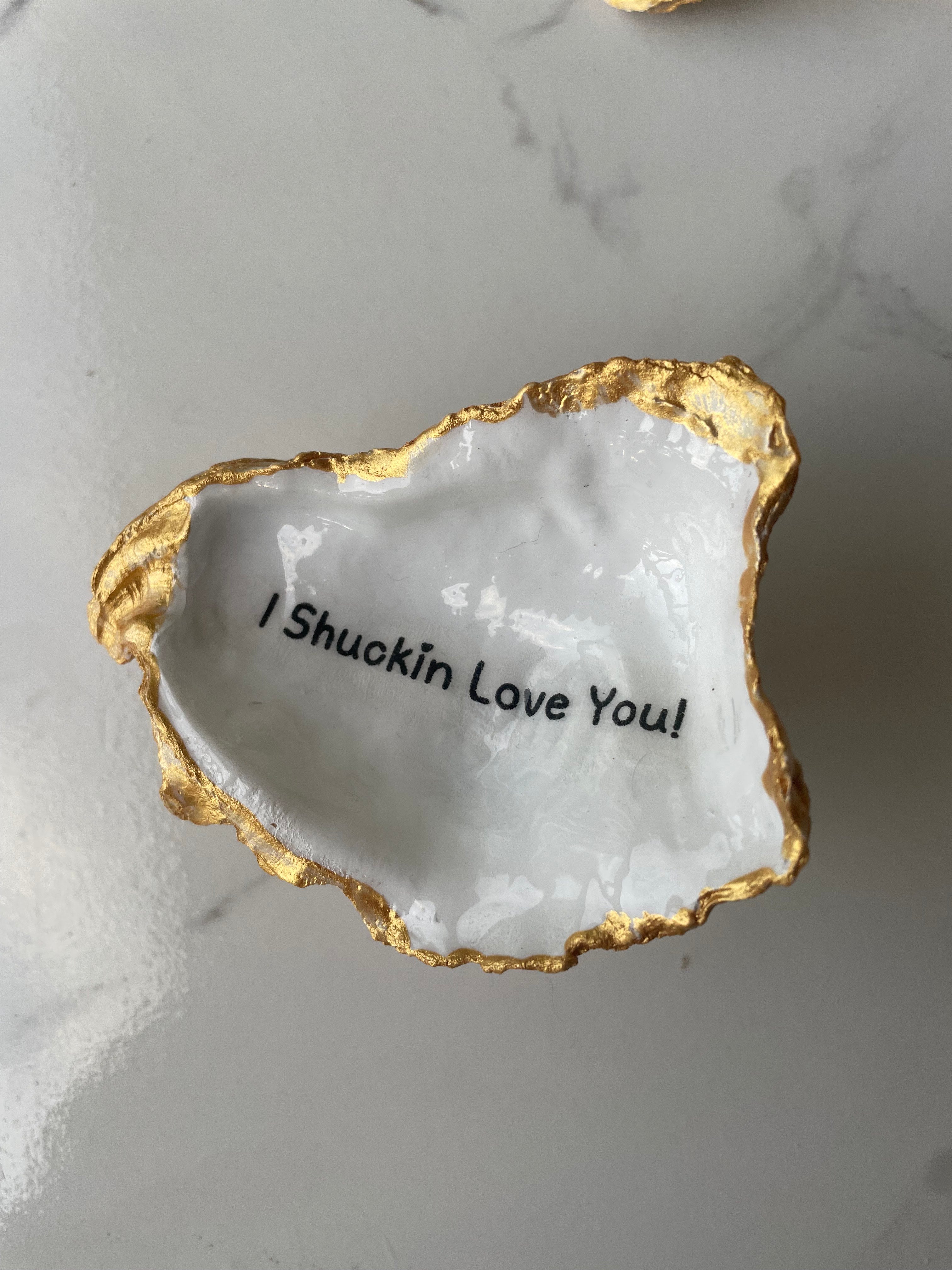 Shore Talk gilded oyster shell trinket dish shown with ring to display size