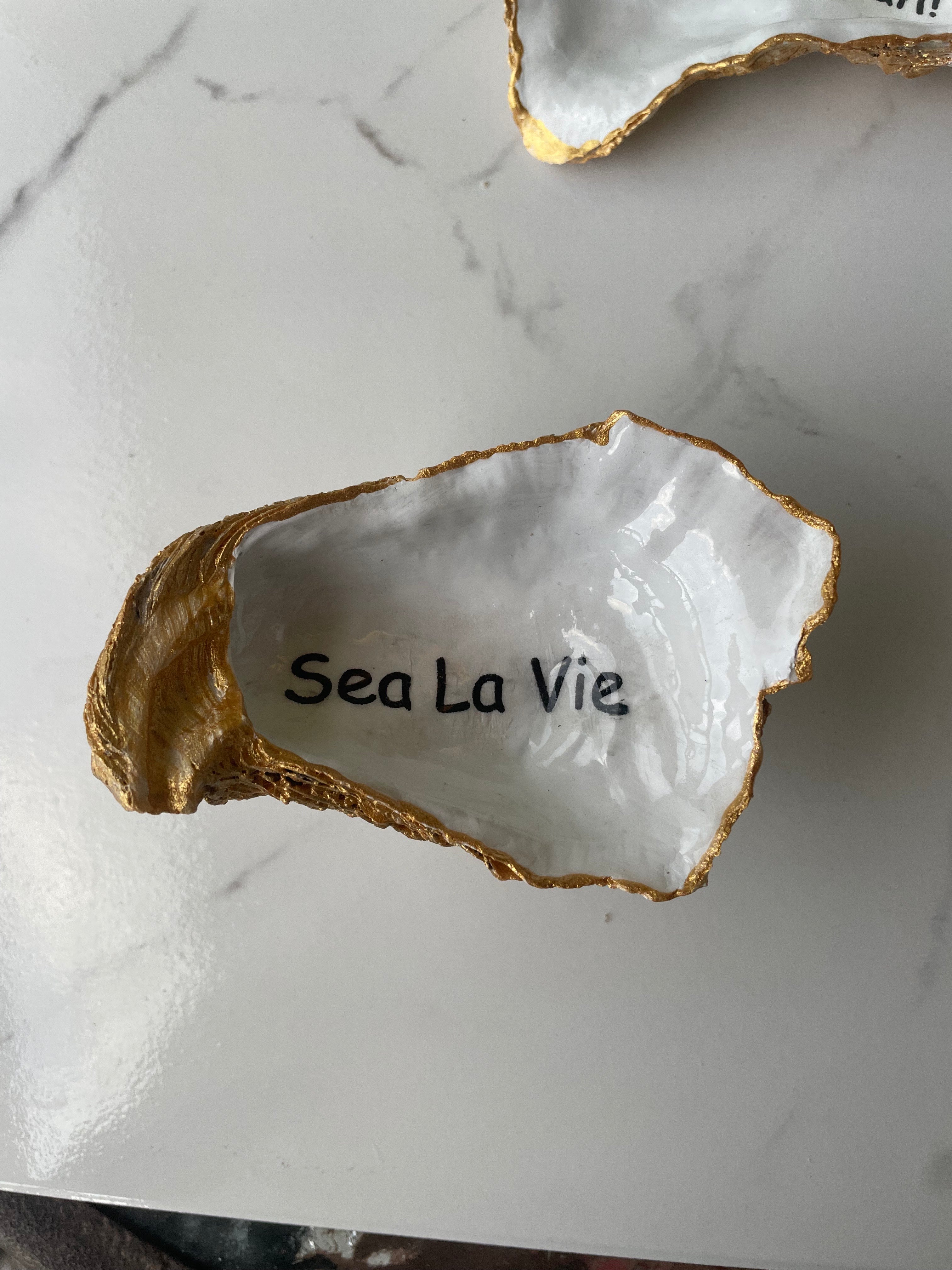 Shore Talk gilded oyster shell trinket dish shown with ring to display size