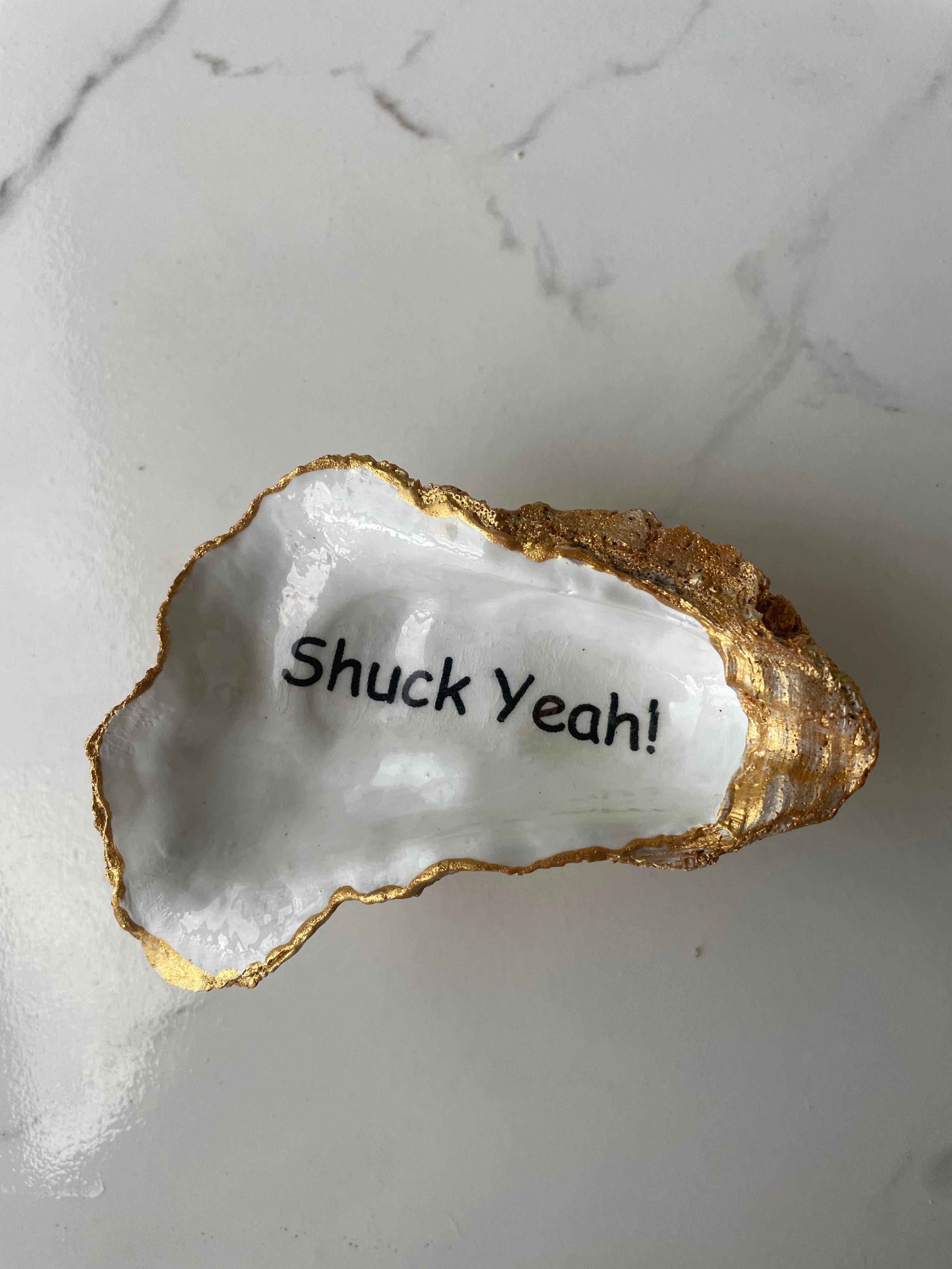 Shore Talk gilded oyster shell trinket dish shown with ring to display size