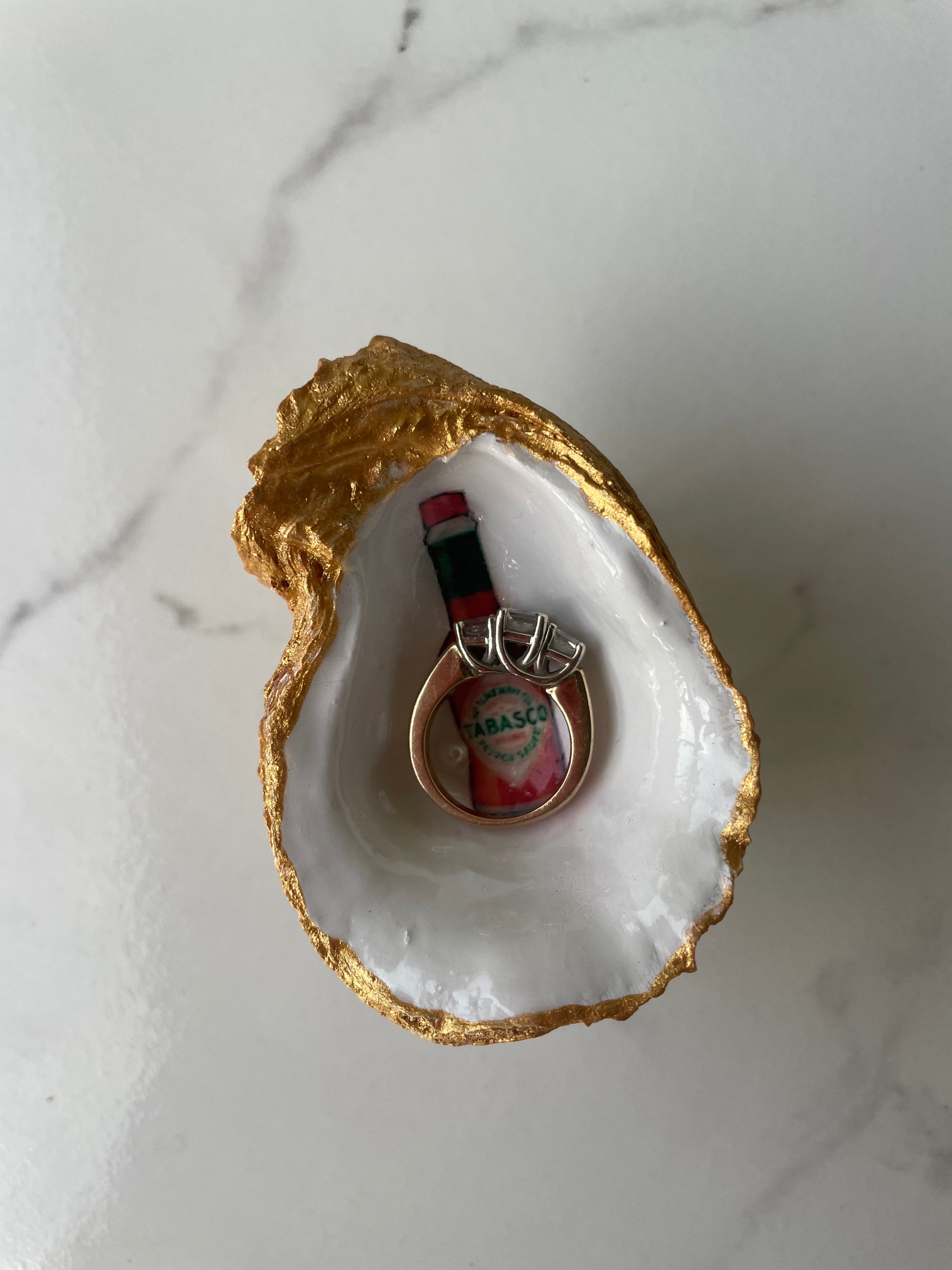 Spicy and Soulful gilded oyster shell trinket dish shown with ring to display size