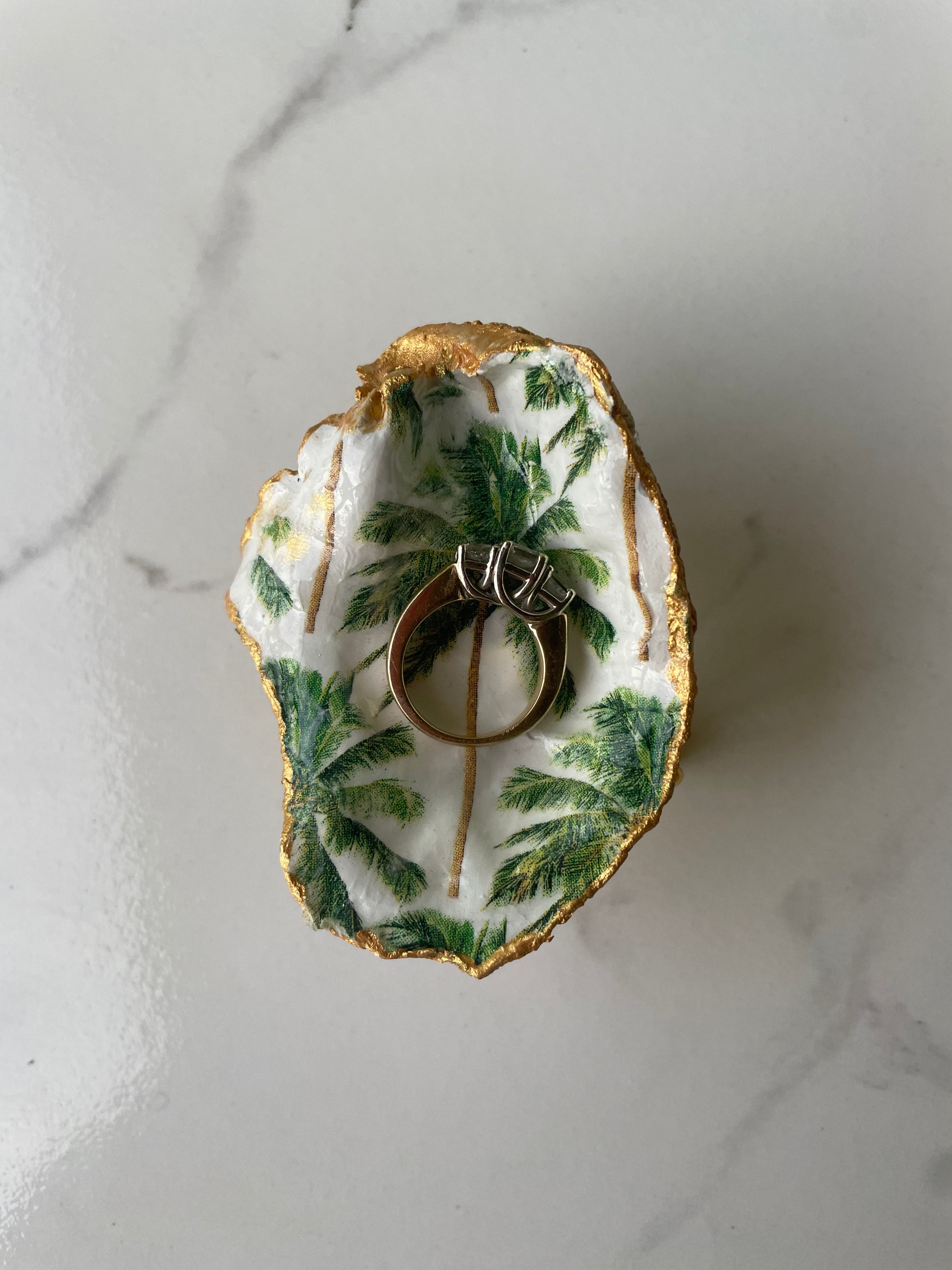 Midnight Palm gilded oyster shell trinket dish shown with ring to display size