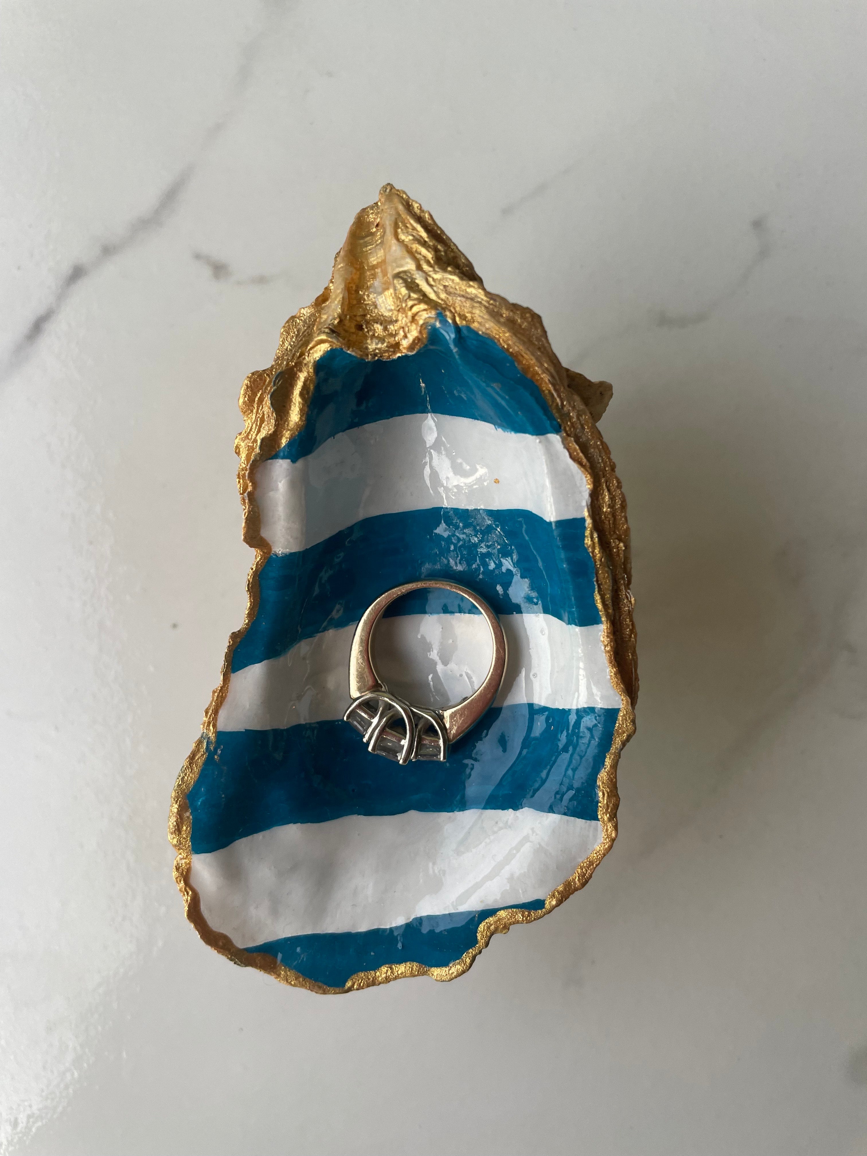 Harbor Blue Stripe gilded oyster shell trinket dish shown with ring to display size