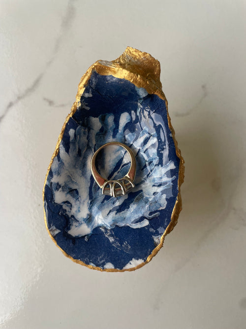 Blue Coral Resilience gilded oyster shell trinket dish shown with ring to display size