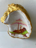 Labrador Paradise oyster shell trinket dish lying flat on its ornate gold display stand, artwork facing up — handmade by The Golden Shoreline