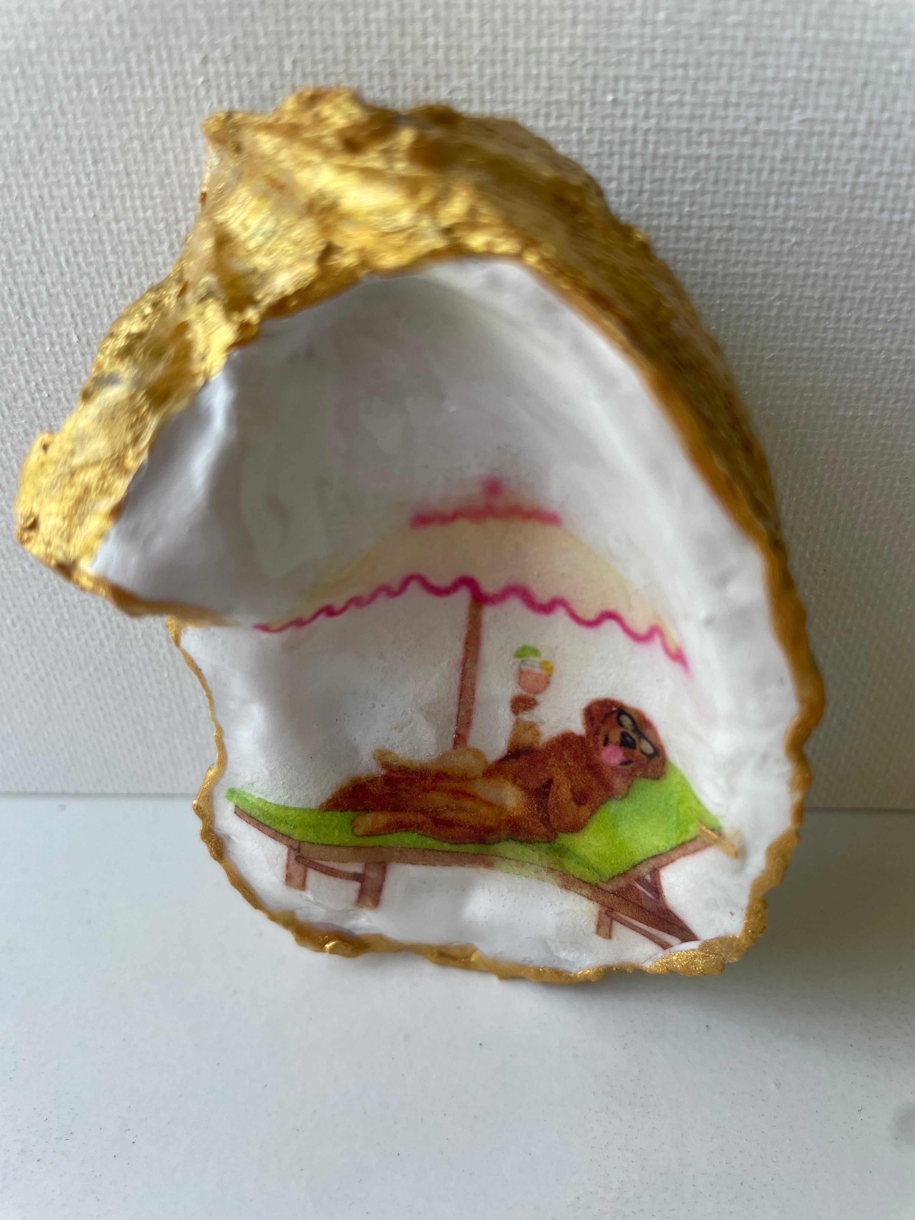 Labrador Paradise oyster shell trinket dish lying flat on its ornate gold display stand, artwork facing up — handmade by The Golden Shoreline