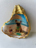 Frenchie Paradise gilded oyster shell ring dish propped up to show artwork — hand-painted French Bulldog beach scene with gold paint edging, handmade by The Golden Shoreline