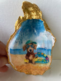 Hero shot of Dachshund Paradise gilded oyster shell dish with gold paint edging.
