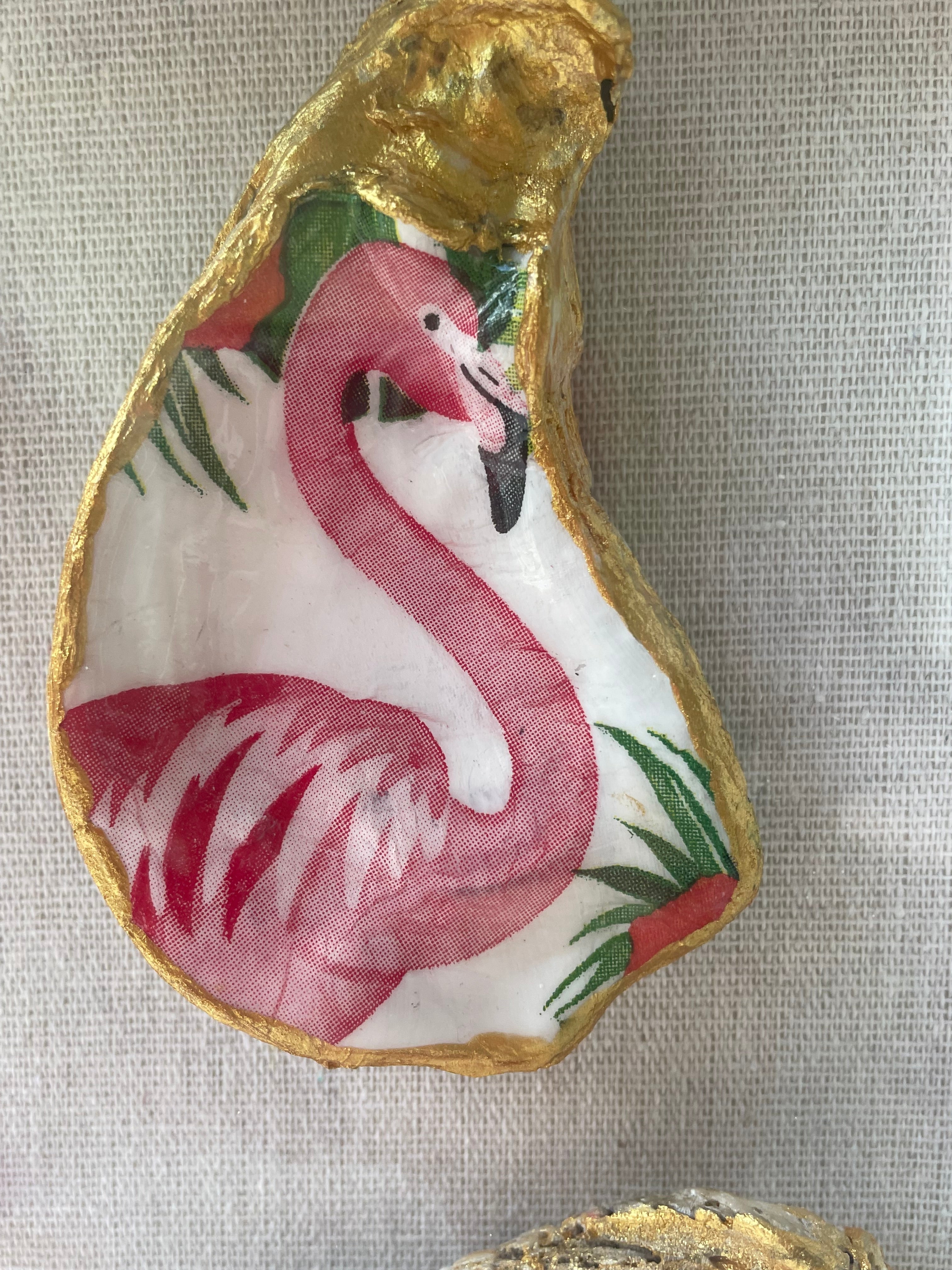 Close-up of flamingo decoupage oyster shell with gold paint edges from The Flamingo Waltz gilded shell shadowbox by The Golden Shoreline