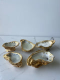 The Shoreline Trio oyster shell candles grouped on a table — handcrafted coastal candles with gold paint edges by The Golden Shoreline
