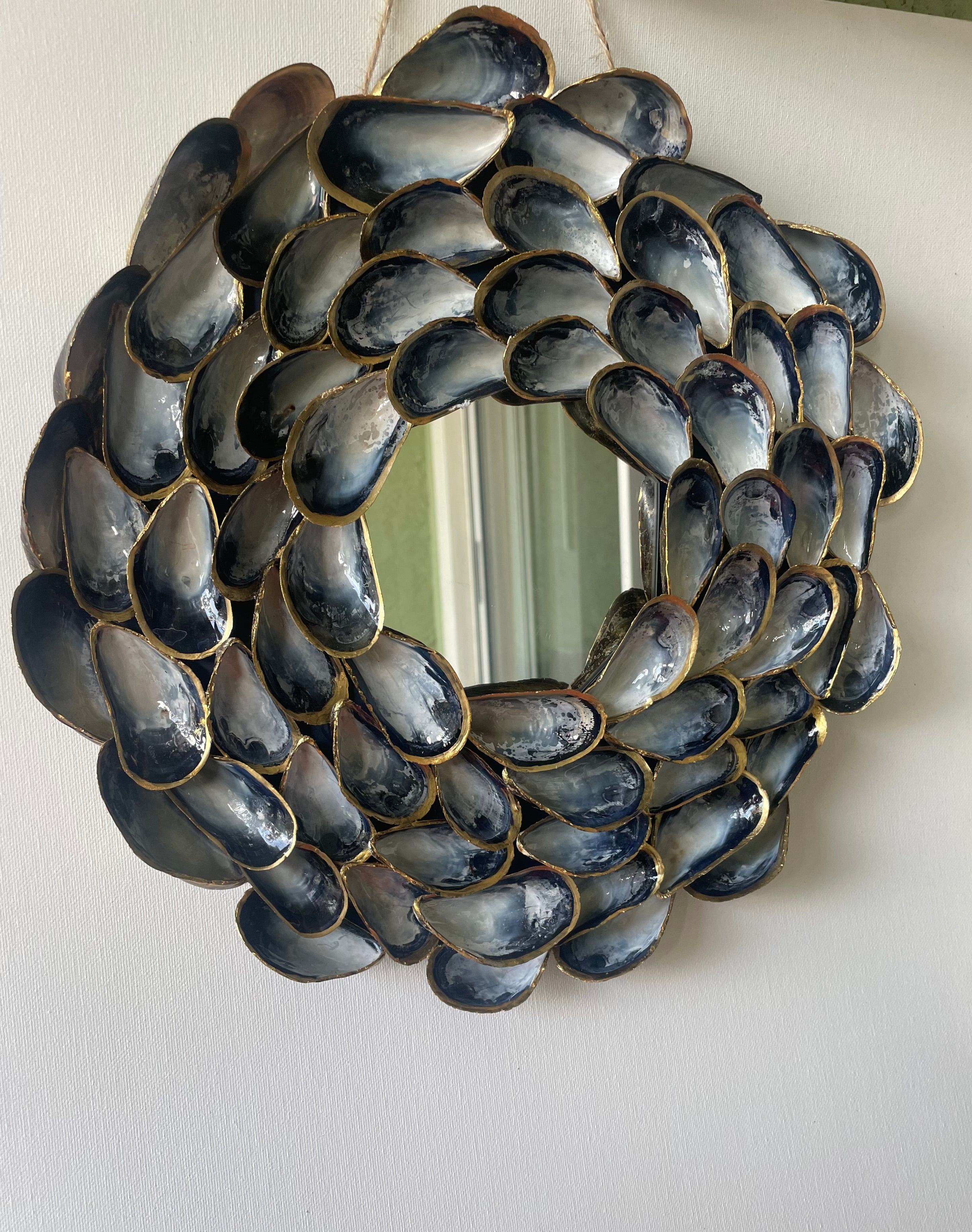 "Handcrafted mussel shell wreath with gold paint edges in deep charcoal, pearl, and midnight-blue tones — Midnight Tide by The Golden Shoreline"