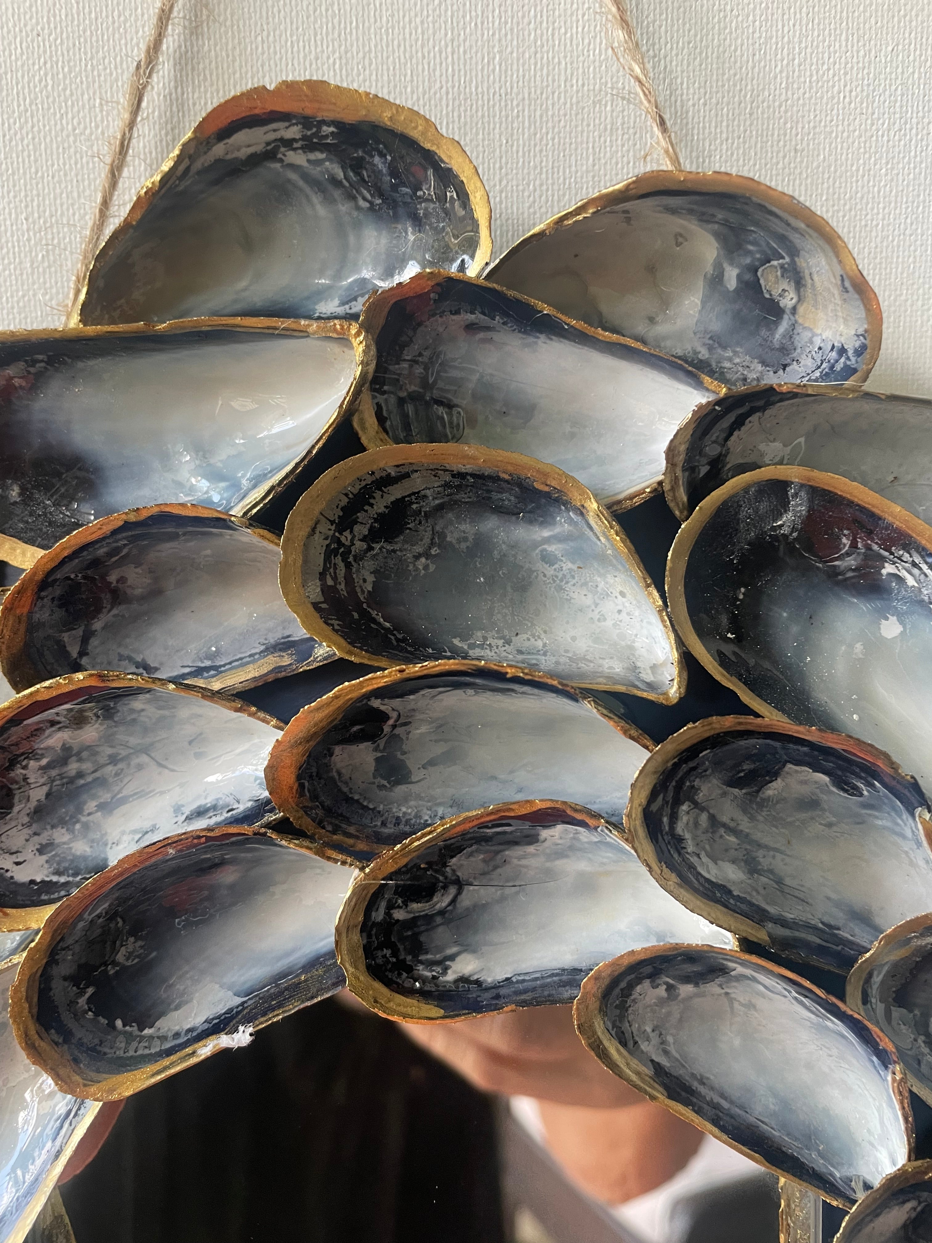 Close up of Handcrafted mussel shell wreath with gold paint edges in deep charcoal, pearl, and midnight-blue tones — Midnight Tide by The Golden Shoreline
