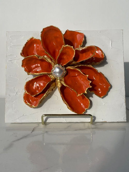 Handcrafted oyster shell flower with coral finish, gold paint edges, and pearl center, mounted on a textured canvas board — The Golden Shoreline
