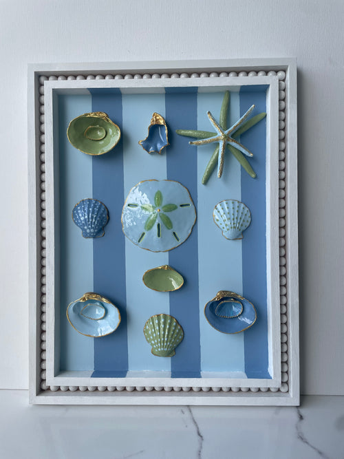 Original coastal wall art with oyster shells, starfish, and gold accents in an 11x14 wood frame"