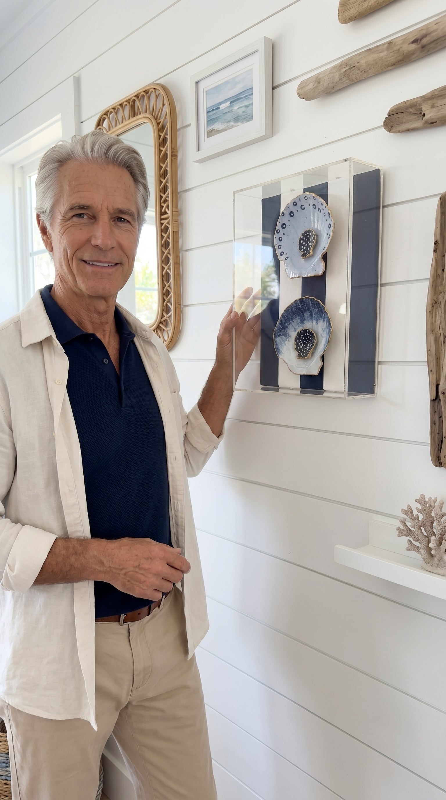 AI lifestyle image of the Nautical Shell Duo gilded shadowbox styled in a coastal interior setting